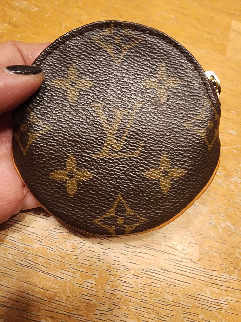 classic Louis Vuitton Monogram round coin purse, crafted in the signature brown